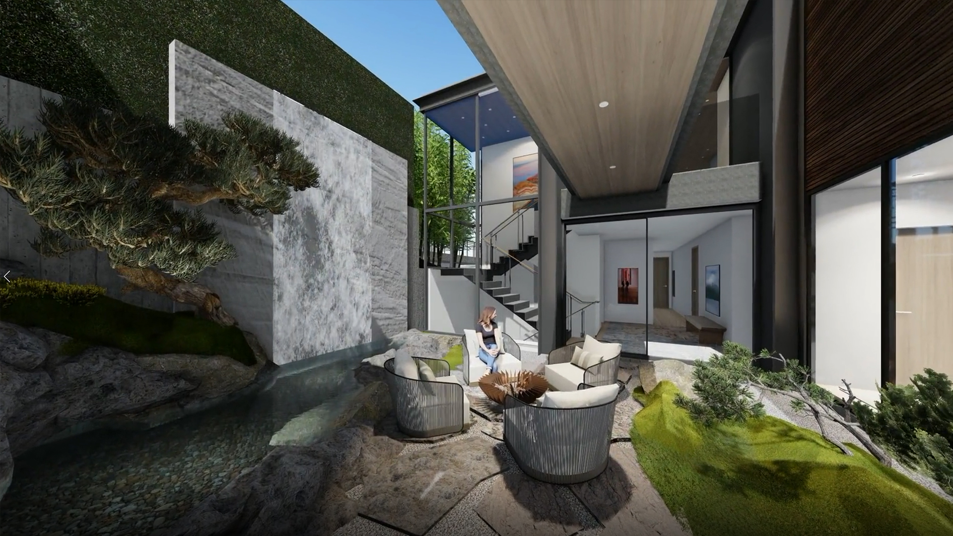 Contemporary courtyard of a modern home with stone walls, a water feature, and a circular seating area.